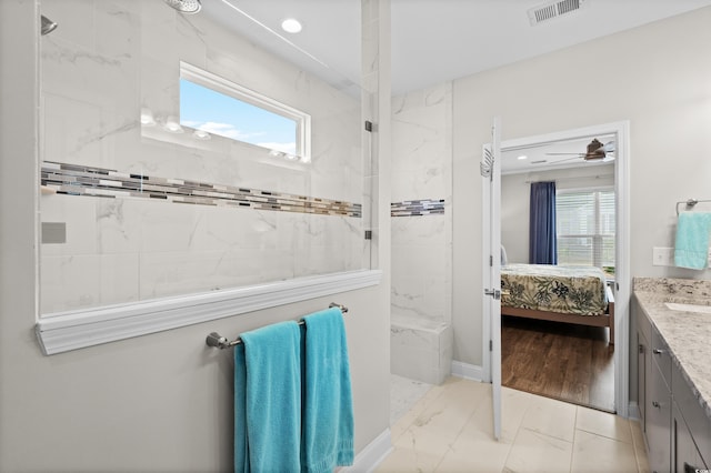 bathroom featuring visible vents, vanity, marble finish floor, a marble finish shower, and ensuite bath