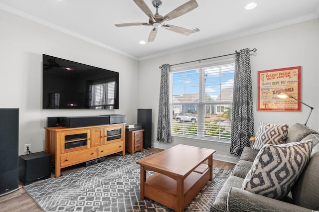 living room featuring a ceiling fan, visible vents, wood finished floors, ornamental molding, and recessed lighting