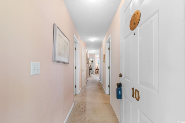 corridor featuring a textured ceiling