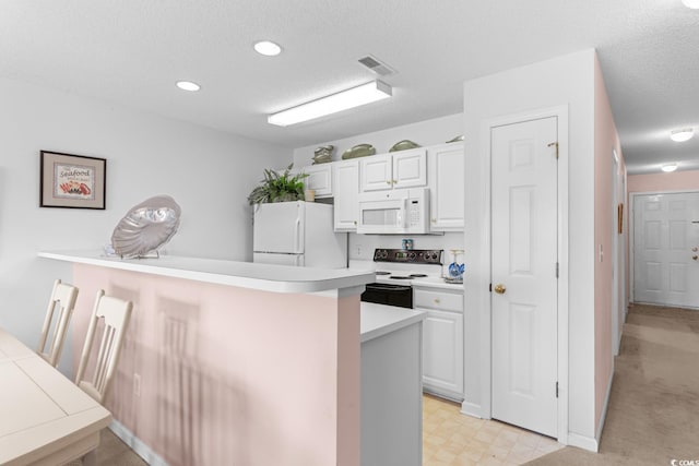 kitchen featuring a kitchen breakfast bar, white cabinetry, white appliances, and a textured ceiling