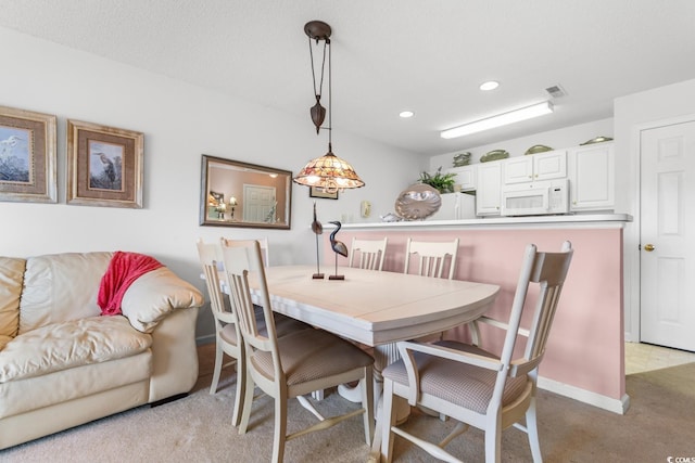 dining room with light carpet