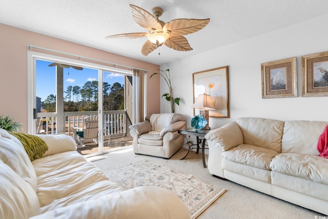 carpeted living room featuring a textured ceiling and ceiling fan