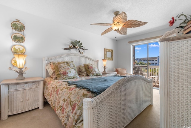 bedroom featuring a textured ceiling, ceiling fan, access to exterior, and light carpet