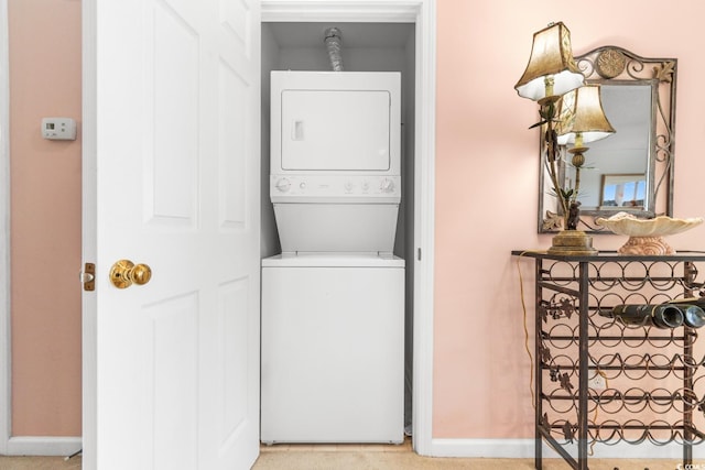 laundry room with stacked washer / dryer