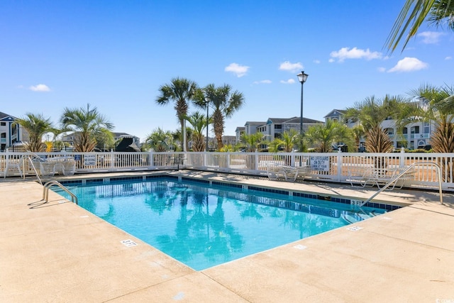 view of swimming pool with a patio