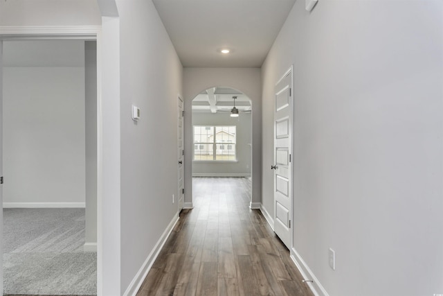 corridor with beamed ceiling, wood-type flooring, and coffered ceiling