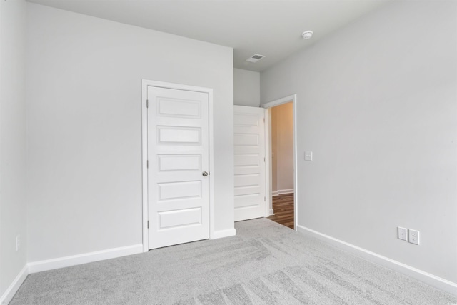 unfurnished bedroom featuring carpet and a closet