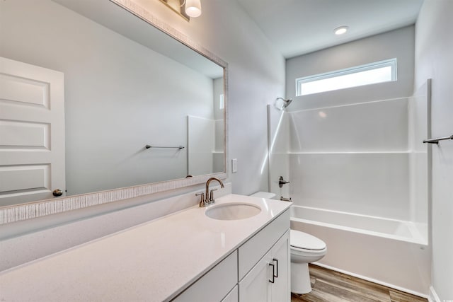 full bathroom with vanity, toilet, wood-type flooring, and shower / tub combination