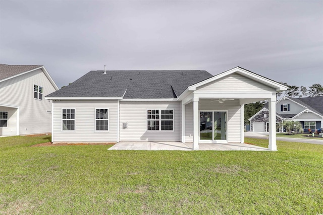 rear view of property with a lawn, ceiling fan, and a patio