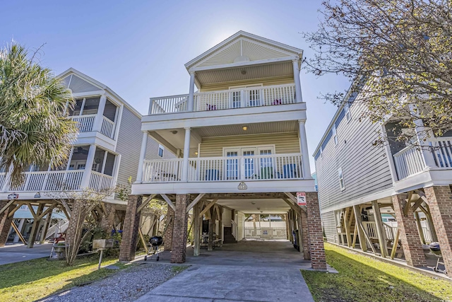 coastal home featuring a balcony and a carport