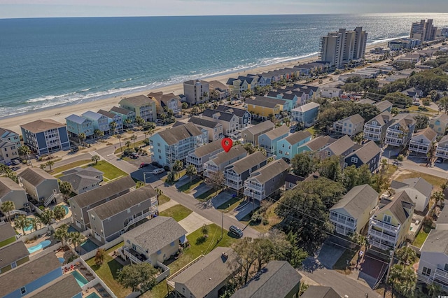 birds eye view of property with a water view and a view of the beach