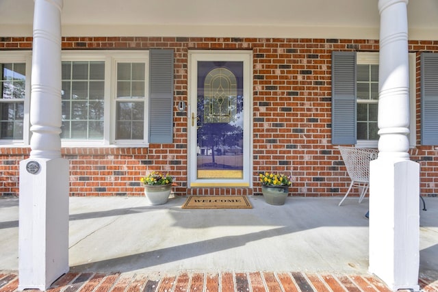 view of exterior entry featuring a porch