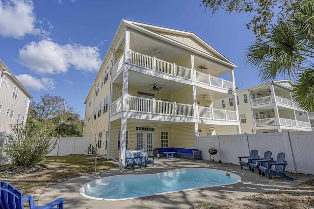 back of house featuring ceiling fan, french doors, an outdoor hangout area, a balcony, and a patio