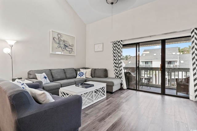 living room featuring high vaulted ceiling and hardwood / wood-style flooring