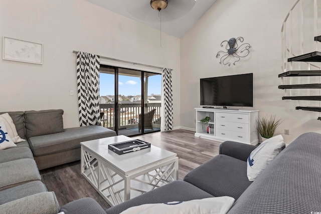 living room with hardwood / wood-style flooring, high vaulted ceiling, and ceiling fan