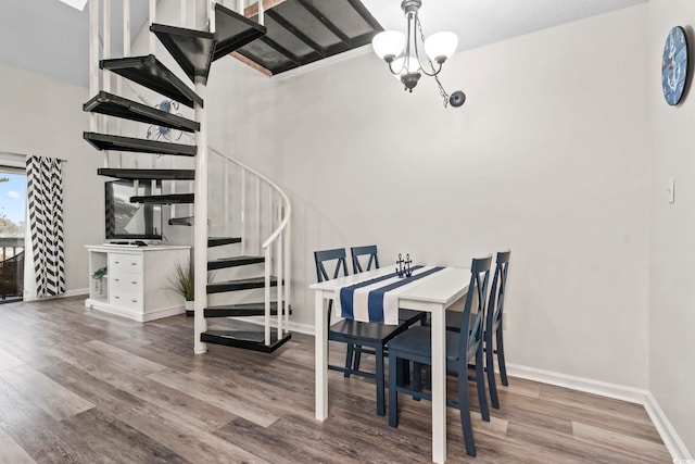 dining area featuring hardwood / wood-style flooring and a notable chandelier