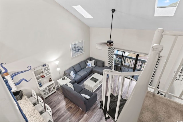 living room with a skylight, high vaulted ceiling, and wood-type flooring