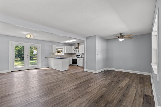 unfurnished living room with french doors, sink, a textured ceiling, dark hardwood / wood-style floors, and ceiling fan