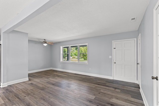 interior space featuring ceiling fan, dark wood-type flooring, and a textured ceiling