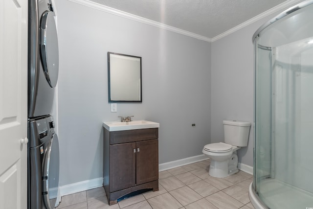 bathroom with tile patterned floors, crown molding, a textured ceiling, stacked washer / drying machine, and vanity