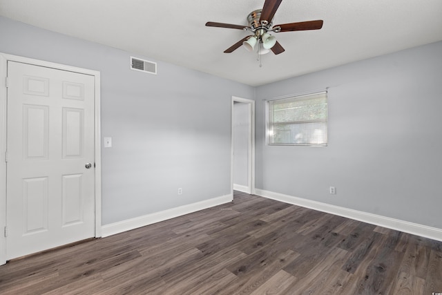 spare room featuring ceiling fan and dark hardwood / wood-style flooring