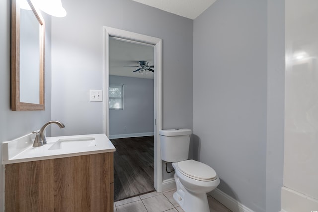 bathroom with vanity, ceiling fan, tile patterned flooring, and toilet