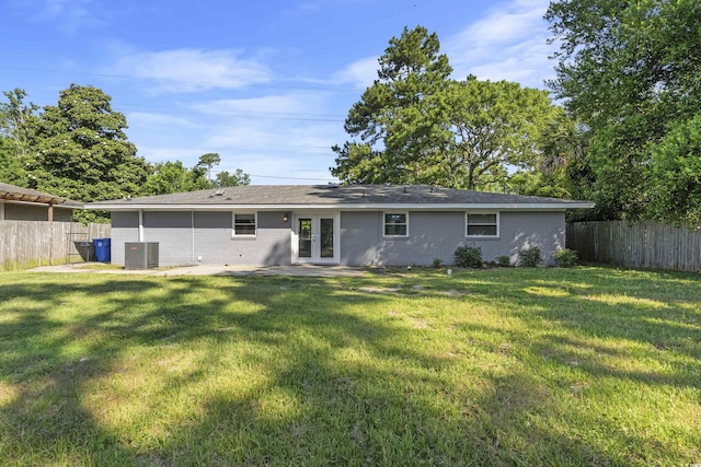 back of property featuring a yard, french doors, and central air condition unit