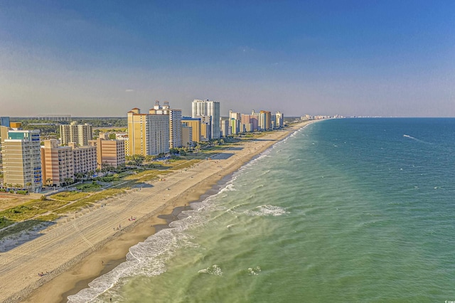 drone / aerial view with a water view and a beach view