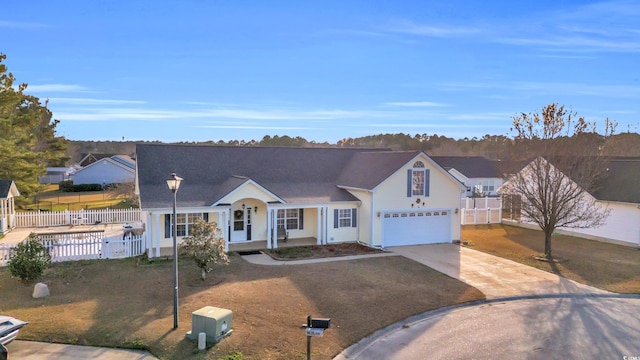 ranch-style house featuring a front lawn, a porch, and a garage