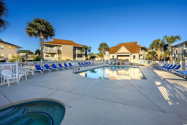 view of swimming pool featuring a patio area and a community hot tub