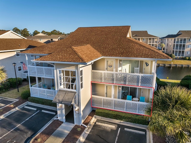 rear view of house featuring a water view