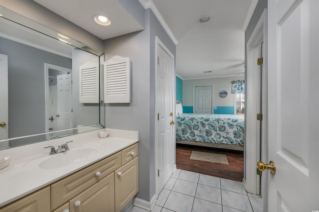 bathroom featuring tile patterned floors, vanity, and ornamental molding