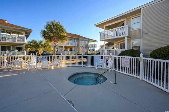 view of pool with a patio area and a hot tub