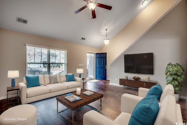 living room with dark hardwood / wood-style flooring, ceiling fan, and lofted ceiling