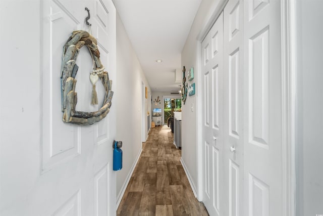 corridor with dark hardwood / wood-style flooring