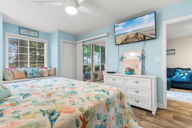 bedroom featuring access to exterior, ceiling fan, and hardwood / wood-style floors