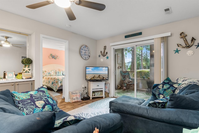 living room featuring ceiling fan and light wood-type flooring