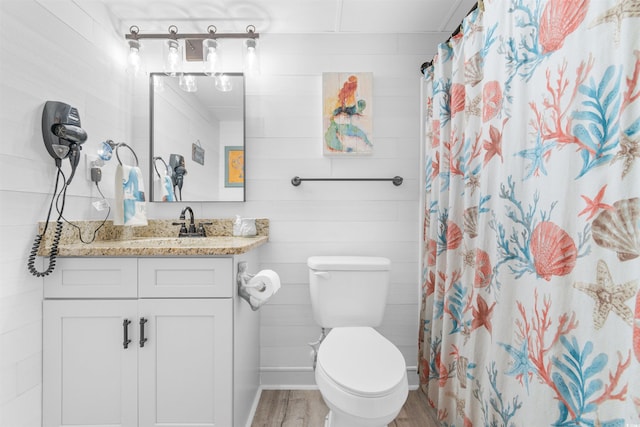 bathroom featuring vanity, hardwood / wood-style flooring, toilet, and curtained shower