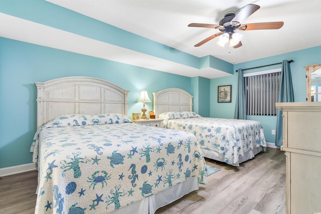 bedroom featuring light wood-type flooring and ceiling fan