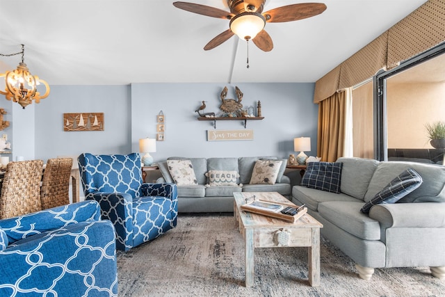 living room featuring ceiling fan with notable chandelier