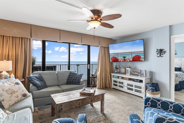 living room featuring ceiling fan and hardwood / wood-style flooring