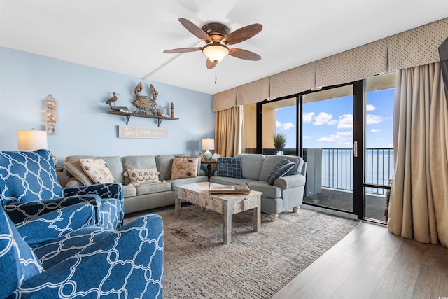 living room featuring wood-type flooring and ceiling fan