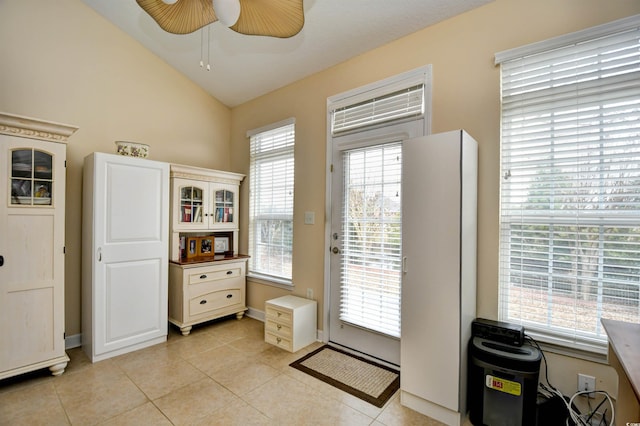 entryway with plenty of natural light, ceiling fan, and light tile patterned floors