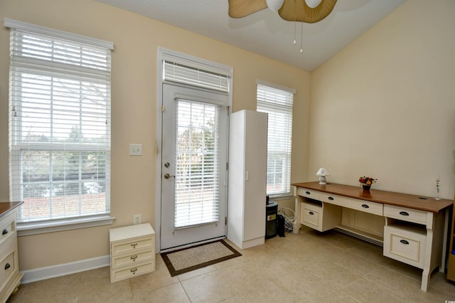 doorway featuring ceiling fan, light tile patterned floors, and a healthy amount of sunlight