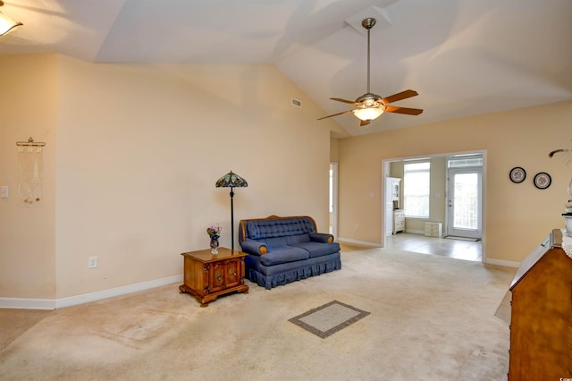 sitting room with ceiling fan, light carpet, and vaulted ceiling