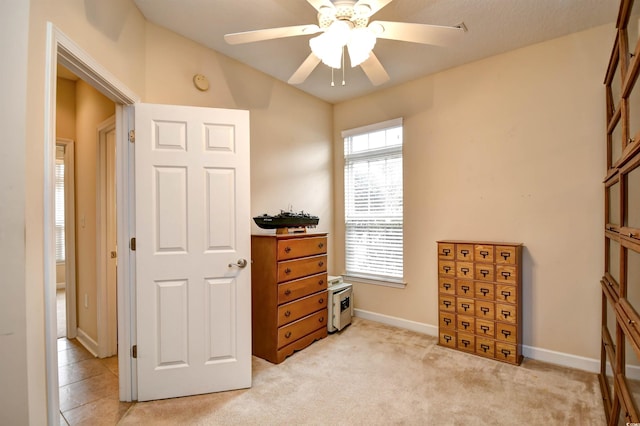 miscellaneous room with ceiling fan and light carpet