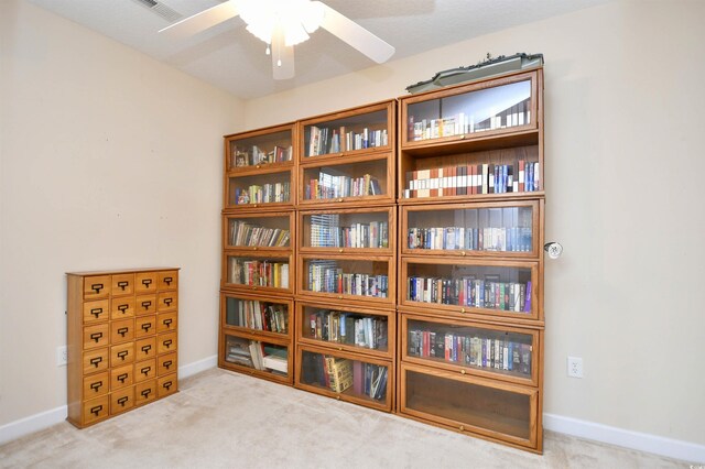 interior space featuring carpet and ceiling fan