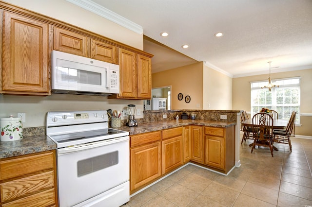 kitchen with an inviting chandelier, kitchen peninsula, pendant lighting, white appliances, and ornamental molding