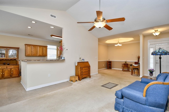 carpeted living room featuring ceiling fan with notable chandelier, vaulted ceiling, and ornamental molding