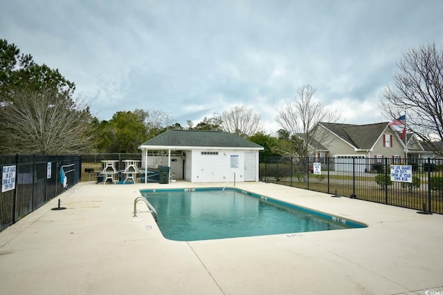 view of swimming pool with an outbuilding and a patio area